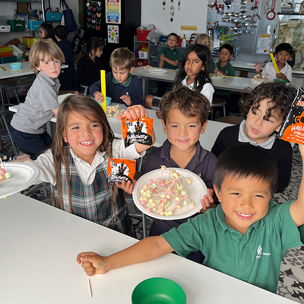 Students displaying a project in a school maker space